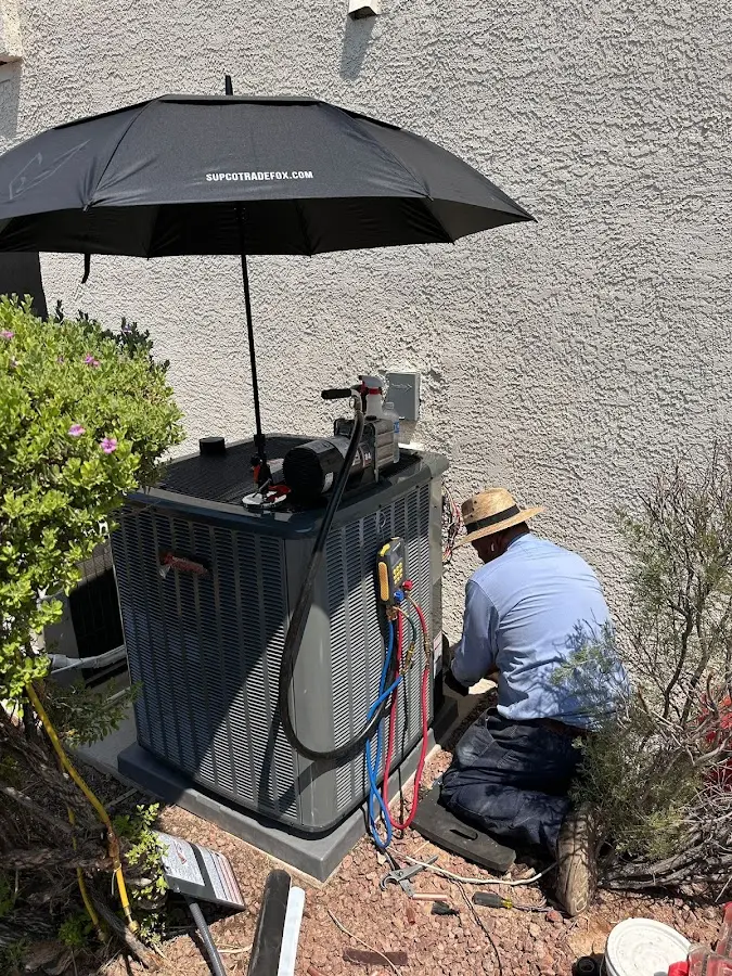 HVAC technician performing outdoor AC maintenance in Tamaqua